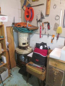 Corner basement contents. Some items included are portable heaters and miscellaneous tools