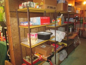 Entire contents of 4 shelves shown. Lot includes drinking glasses, decor and various household items