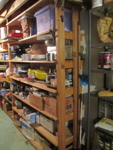 Contents of shelf as shown includes cook and bakeware, picnic basket, household items and more