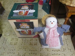A large animated talking cookie jar and a decorative snowman
