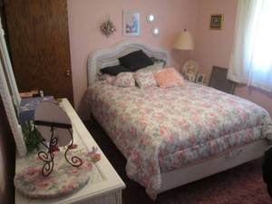 A beautiful wicker bedroom set includes bed and bedding Dresser, chest, bedside table and its contents , rocking chair and magazine holder