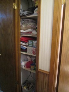 Contents of hallway closet includes towels, washcloths, tissue, and personal care items