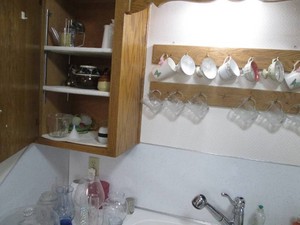 Uranium glass juicer, lidded sugar and creamer dishes, bone China cups, glass mugs, vases and more