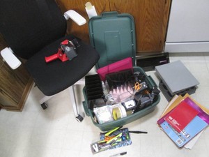 Rolling office chair plus lidded tote overflowing with a wide variety of desk and assorted office supplies