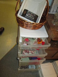 Plastic 4-drawer storage organizer with crafting supplies and wicker baskets