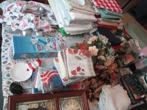 Massive lot of assorted table coverings, napkins, place mats, napkin rings, center pieces, wall decor and more