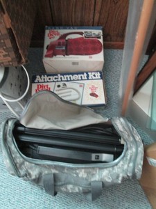 Oreck travel vacuum cleaner with attachments and camouflage duffle bag plus Dirt Devil hand vac with attachment kit