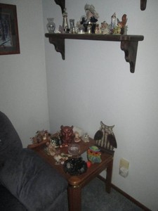 Wood end table with (2) glass pane inlays, Owl collectibles, ashtray, brass tone miniatures, and a variety of assorted home decor