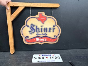 Shiner Bock wooden, double-sided hanging sign, and Shiner TX license plate