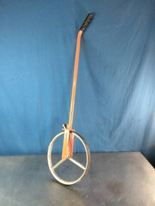 A orange metal frame measuring wheel, which resembles a Keson MP401 Metal Professional Spoked Measuring Wheel.