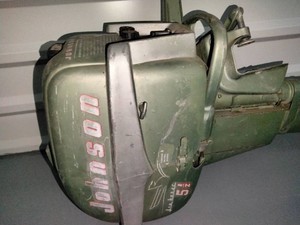 A vintage green Johnson Sea-Horse 5 12 hp outboard motor, likely from the mid-1950s
