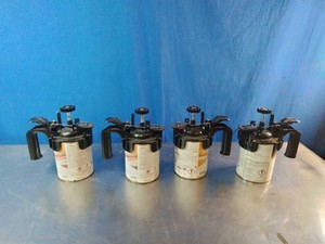 Four paint cans equipped with manual hand-crank mixing lids,