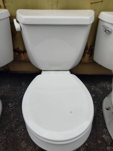 Standard Kohler two-piece porcelain flush toilet featuring a classic white tank, bowl, and closed lid.