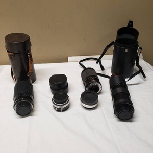 Camera lenses and accessories including Vivitar Macro Lens, Quantaray Zoom Lens, Kenko 2x Teleconverter, and Vivitar Automatic Teleconverter with cases.