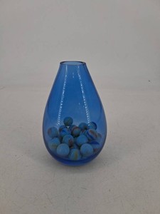 Blue Glass Vase Filled With Assorted Marbles