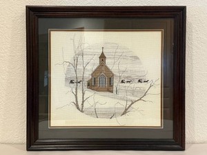 Framed Cross Stitch depicting P. Buckley Moss Church Scene