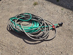 Lot of assorted garden hoses with fittings and nozzle