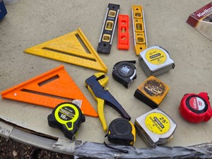 Lot of Hand Tools Including Stanley and Performance Tape Measures, Speed Squares, and Levels