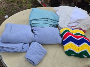 Lot of Blankets and Linens including Multicolored Crochet Blanket, Quilted Blue Blanket, and White Textiles