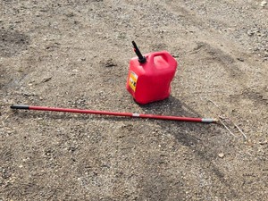 Red Plastic Gasoline Container and Push Broom Handle