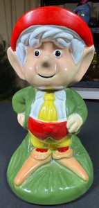 1980s ceramic coin bank of Ernie the Keebler Elf, standing roughly 10 inches tall in a green coat, yellow pants, and a red hat.