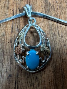 Sterling Silver & 12kt gold pendant with sterling chain  Chain stamped 925 Italy  Pendant stamped STER & 12k 9.1 grams