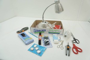 adjustable desk lamp with organizer base, scissors, Velcro, thread