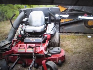 eXmark Zero turn lawn mower with a Kohler engine, runs and mows, 1799 hours, includes bagger and front rake