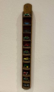 Vintage Mini Diecast Car Models on Wooden Shelf