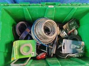 Green organizational bin contains a variety of miscellaneous hardware, wiring, and automotive utility items.