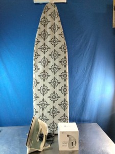 Freestanding ironing board , iron , and a boxed handheld garment steamer.