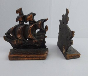 Cast iron ship bookends presented as a matched nautical pair. The bookend set features detailed