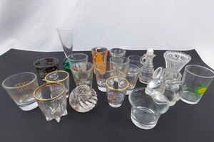 Mixed glassware and barware assortment with tumblers, shot glasses, decanter, vase, and bowl  -
