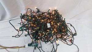Assorted Christmas string lights including multicolor and warm white holiday light strands.  -