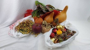 Fall and autumn decor assortment with artificial fruit, gourds, leaves, garlands, and accents.  -