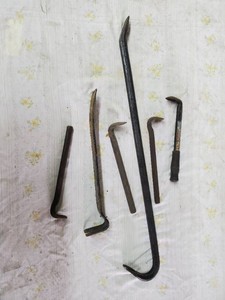 Lot of pry tools includes crow bar, flat bar and cats paws