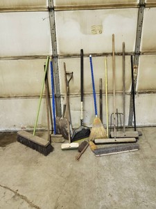 Lot of brooms and handlesaxe handle