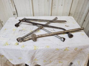 3 lug wrenches and 1 breaker bar