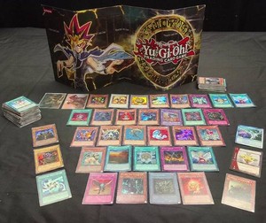 YU-GI-OH CARDS AND PLAYING BOARD AND CARDS