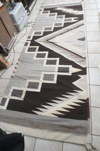 vintage Navajo-style handwoven wool rug featuring a serrated zig zag pattern 12' x 8'