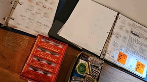 Fishing lures, Titleist golf balls and box of matches
