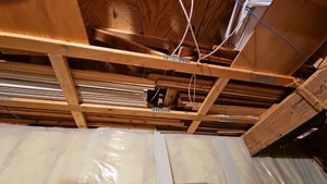various trim and wood pieces stored in ceiling of spare room