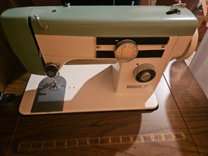Daytons model 215 zig zag sewing machine and cabinet