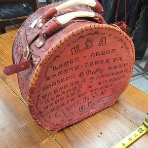 Western Traveling HatTrain Box with authentic antler handles heavily stamped with travel destinations of the Old West
