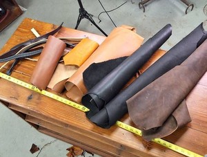 Several medium size pieces of leather and straps