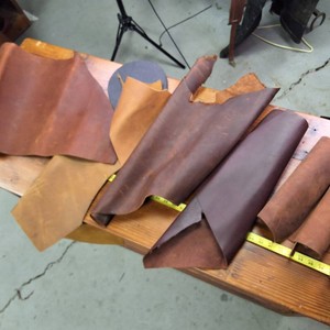 Several small rolls of different dyed leather
