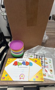 certificate of awards stickers, and two stacks of colorful containers