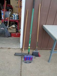 Assorted tools. Brooms & rake. As shown.