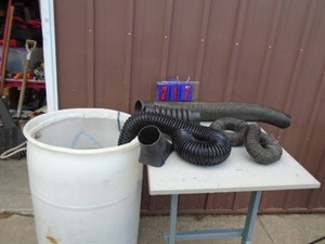 Plastic barrel with assorted hoses & blower attachments. As shown.