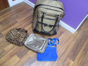 Wheeled suitcase with handbags